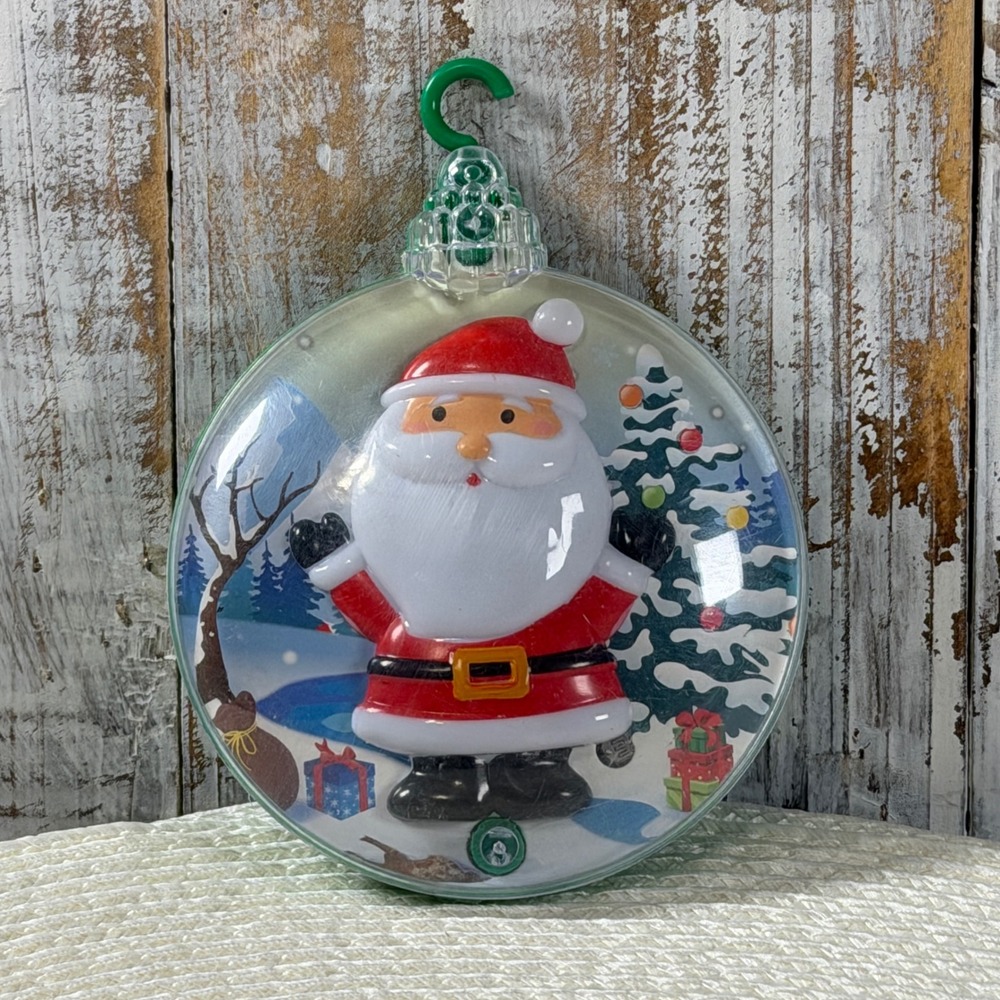 Santa Claus Musical Christmas Ornament 2023 Red Green Round Plastic Holiday Deco
